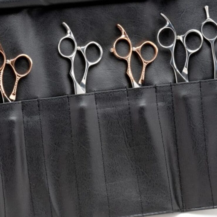 Professional hair cutting scissors and shears side by side on a salon counter