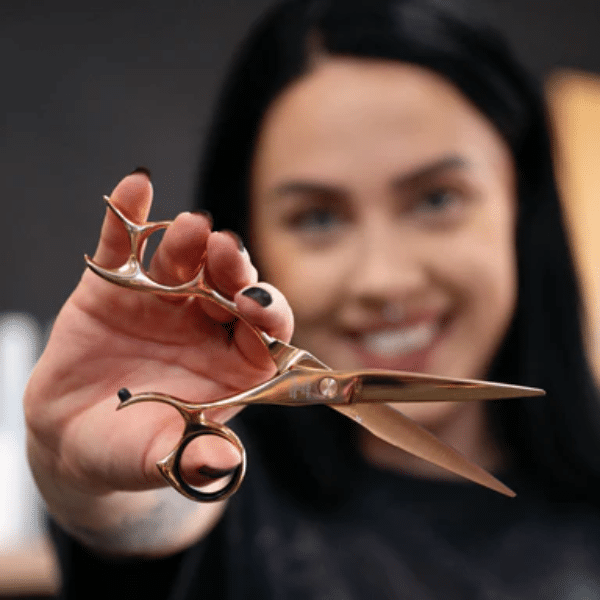 Hairstylist comparing ergonomic shears to pick the right size and handle