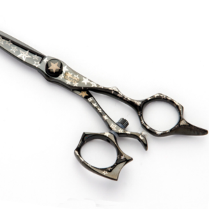 An organized collection of professional hair cutting shears laid out on a salon table 