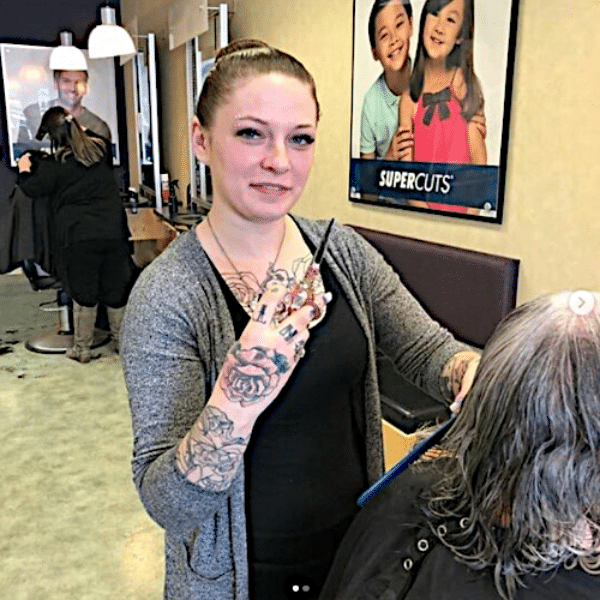 Various professional hair shears and scissors displayed on a salon towel