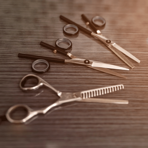 Hair cutting scissors and shears placed side by side showing blade length difference